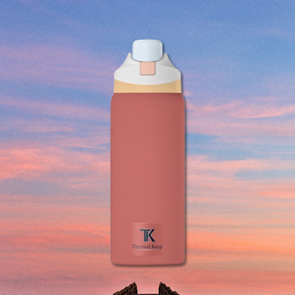 Red stone thermos bottle with white and gold accents on a colorful sky background
